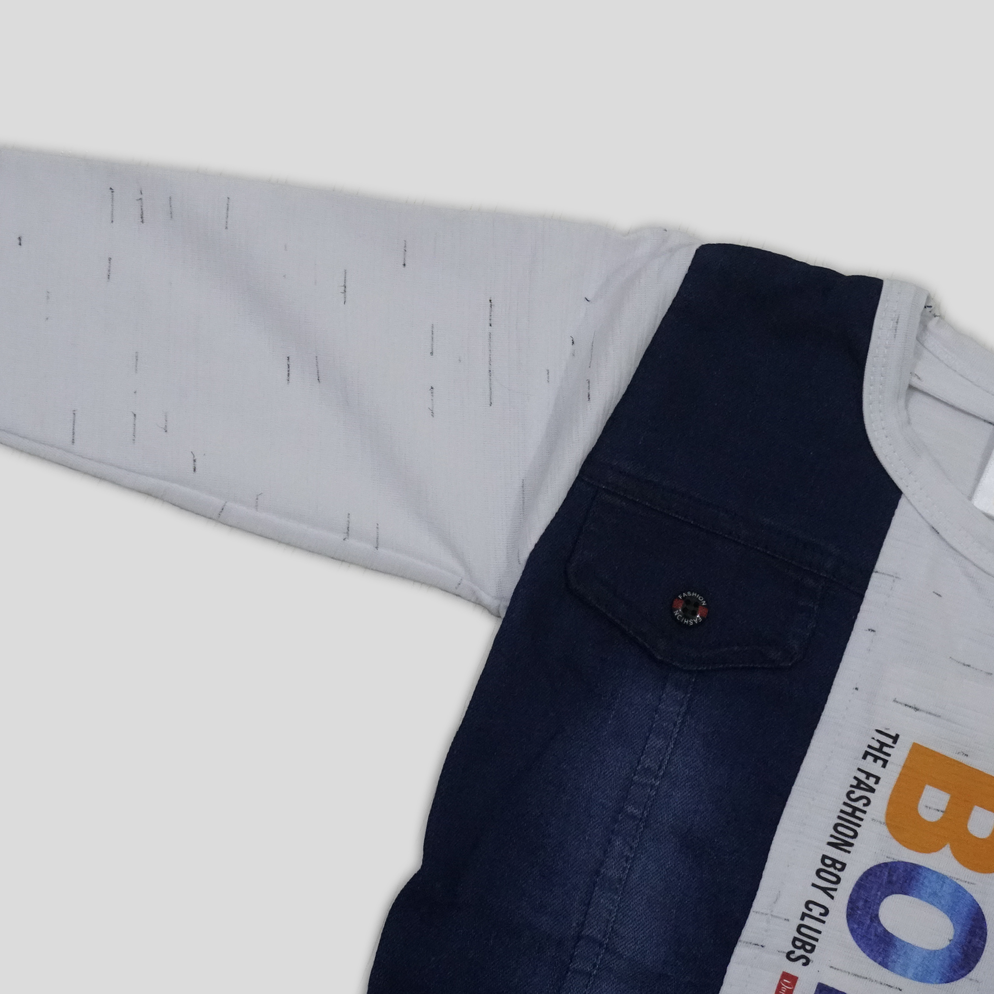 Child wearing a blue and white outfit with 'BOYS' text on a white background