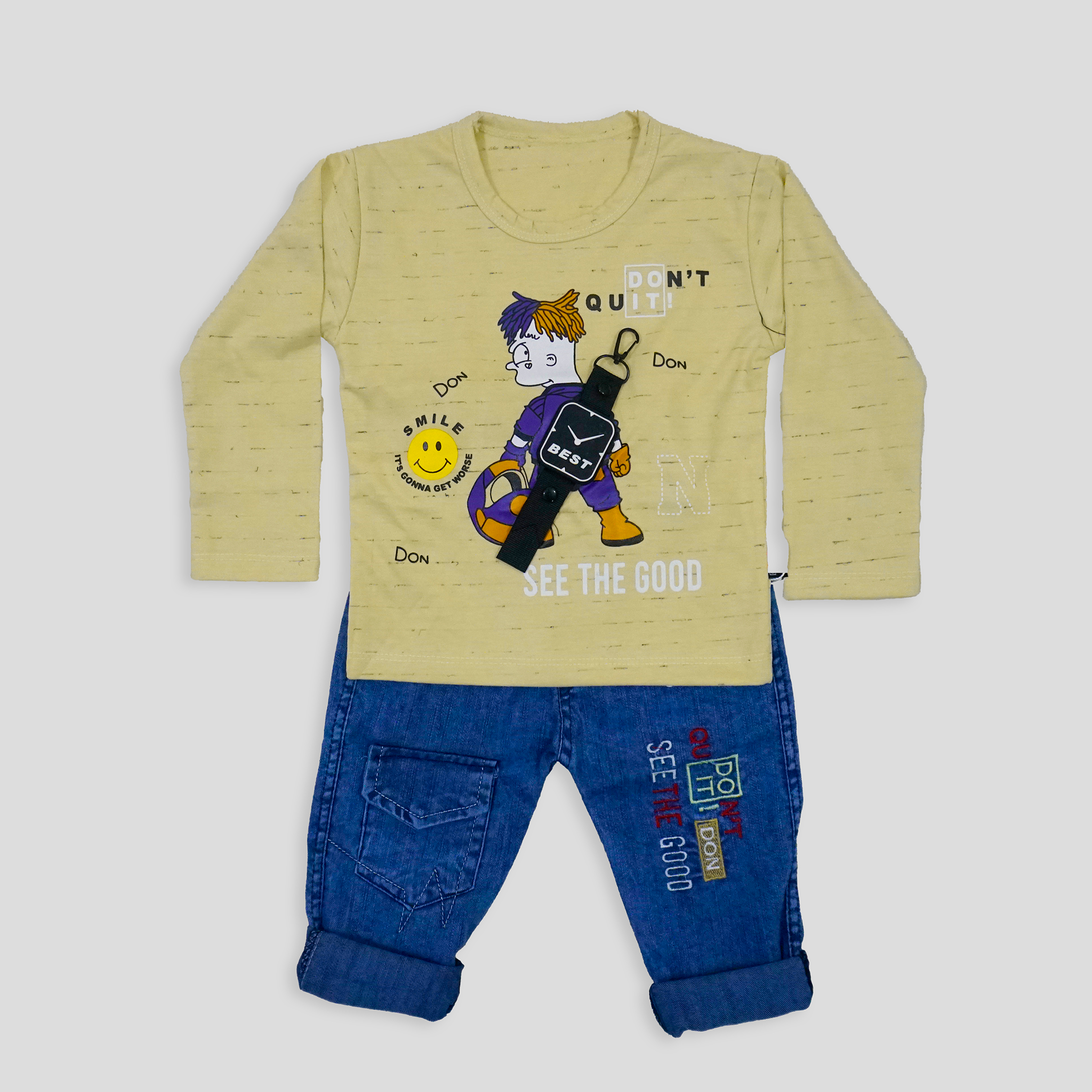 Child wearing a yellow sweater with a graphic design and blue jeans in a room with white walls and a bookshelf.