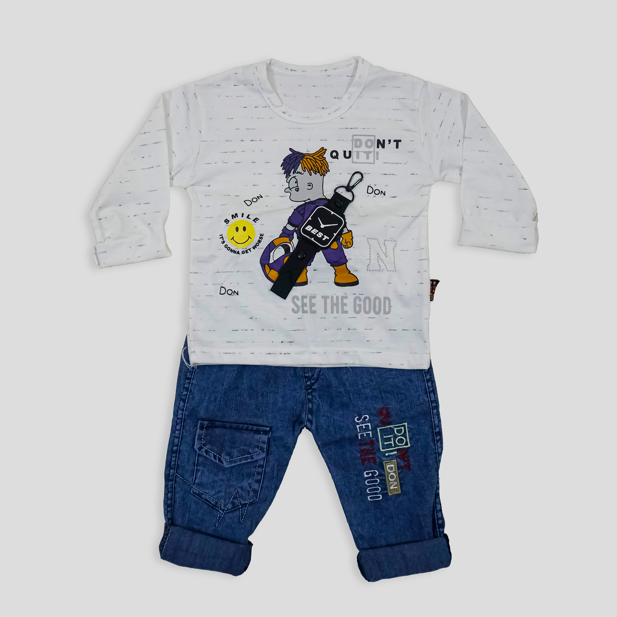 Child wearing a white long-sleeve shirt with a graphic design and blue jeans in a room with a white curtain and bookshelf.